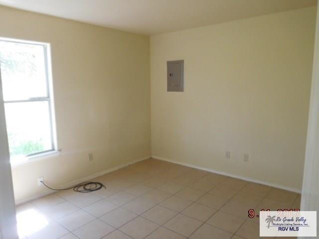 2100 Old Port Isabel Rd, Brownsville, TX 78526 - spare room with electric panel, baseboards, and light tile patterned flooring