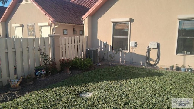 view of home's exterior featuring a yard and central air condition unit