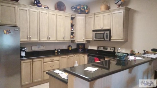 kitchen featuring a breakfast bar, kitchen peninsula, and stainless steel appliances