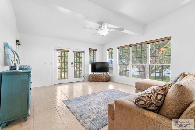 tiled living room with vaulted ceiling with beams, plenty of natural light, ceiling fan, and french doors