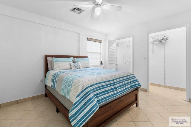 tiled bedroom featuring ceiling fan