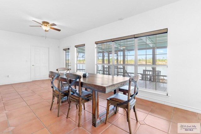 tiled dining space featuring ceiling fan