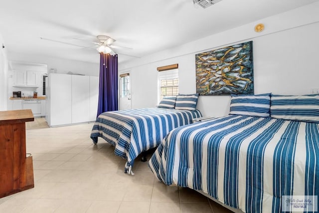 bedroom with light tile patterned floors, ensuite bathroom, and ceiling fan