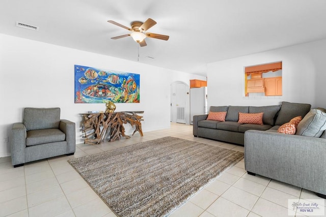 tiled living room featuring ceiling fan