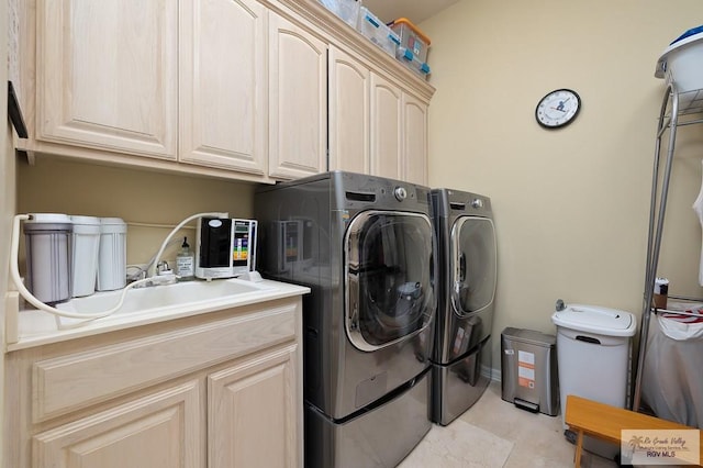 16408 Garrett Rd, Harlingen, TX 78552 - washroom featuring washer and clothes dryer, cabinet space, and light tile patterned floors