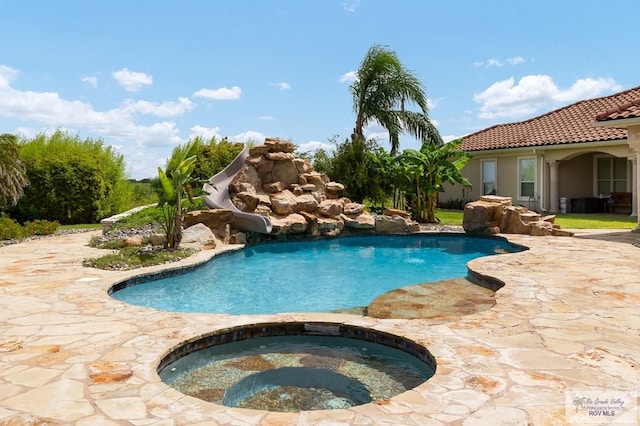16408 Garrett Rd, Harlingen, TX 78552 - swimming pool with a water slide, an in-ground hot tub, and a patio