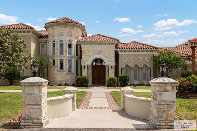 16408 Garrett Rd, Harlingen, TX 78552 - mediterranean / spanish-style home with stone siding, stucco siding, and a tiled roof