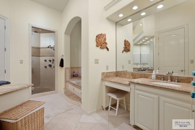 16408 Garrett Rd, Harlingen, TX 78552 - bathroom featuring a garden tub, recessed lighting, tiled shower, vanity, and marble finish floors
