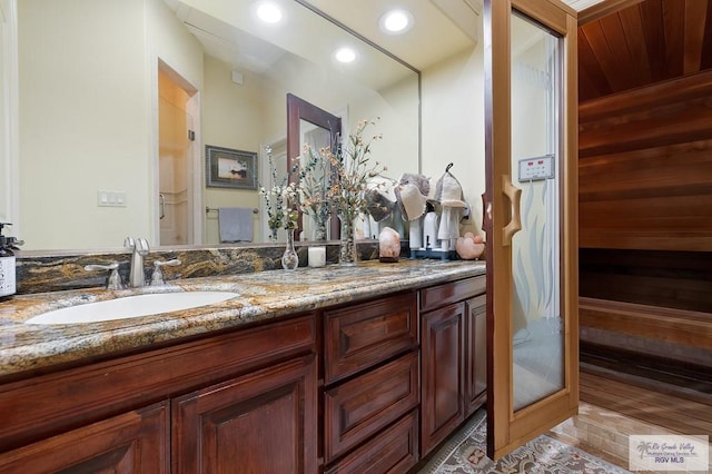 16408 Garrett Rd, Harlingen, TX 78552 - full bathroom with double vanity, recessed lighting, a sauna, wood walls, and tile patterned floors