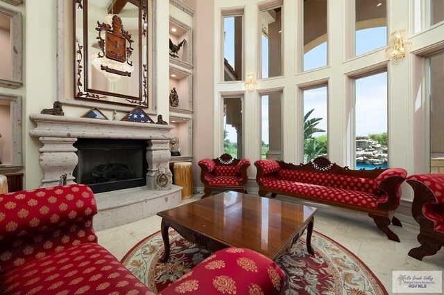 16408 Garrett Rd, Harlingen, TX 78552 - living area with plenty of natural light, a towering ceiling, and a premium fireplace