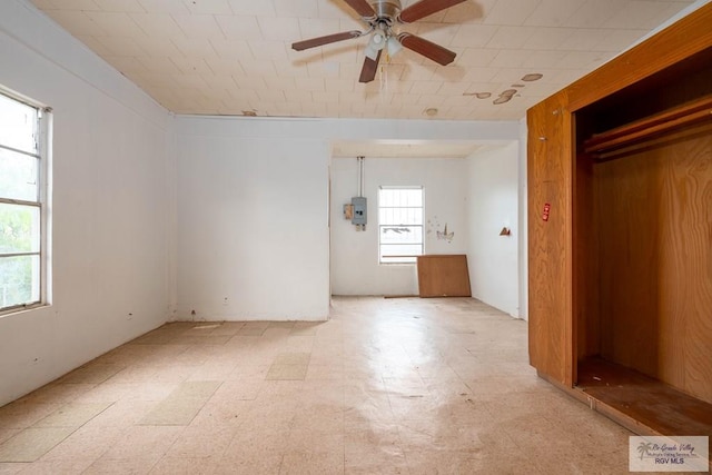 interior space featuring a closet, multiple windows, and ceiling fan