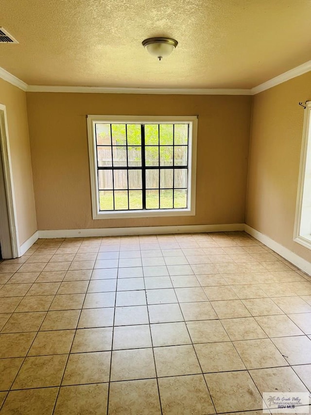1201 Ben Lora Ln, San Benito, TX 78586 - spare room featuring a textured ceiling, ornamental molding, and light tile patterned flooring