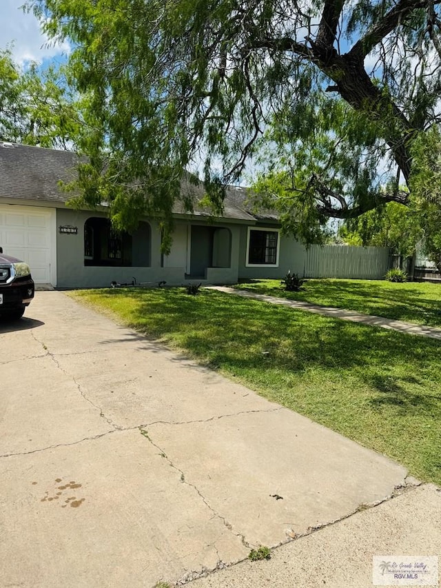 1201 Ben Lora Ln, San Benito, TX 78586 - ranch-style home featuring concrete driveway, stucco siding, and an attached garage