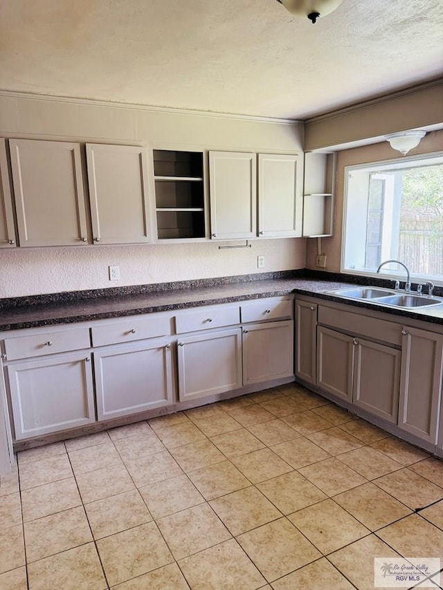 1201 Ben Lora Ln, San Benito, TX 78586 - kitchen featuring open shelves, dark countertops, and light tile patterned floors