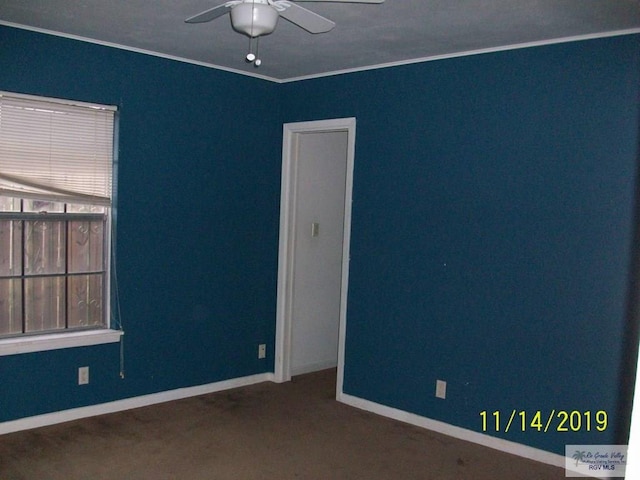 carpeted empty room with ceiling fan and ornamental molding