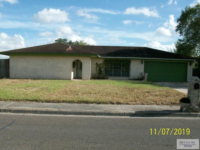 ranch-style home with a front yard and a garage