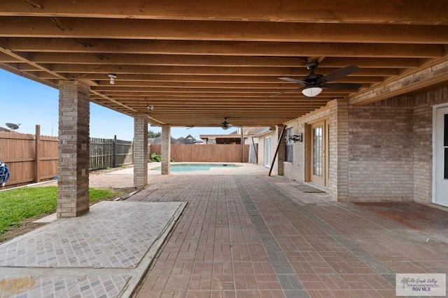 view of patio / terrace featuring ceiling fan and a fenced in pool