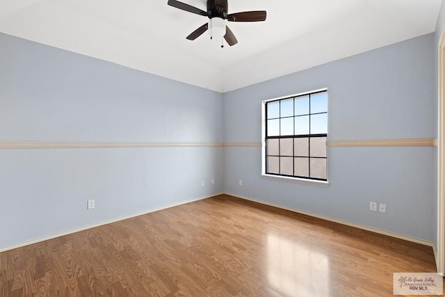 empty room featuring ceiling fan, vaulted ceiling, and light hardwood / wood-style flooring