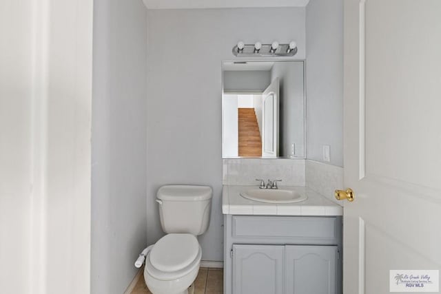 bathroom with toilet and vanity