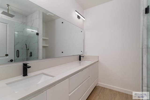 660 Tamarindo Ln Unit 2, Brownsville, TX 78521 - full bath with a marble finish shower, wood finished floors, and double vanity