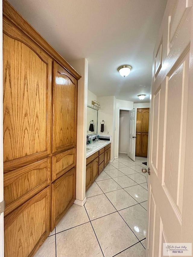 bathroom featuring tile patterned flooring and double vanity