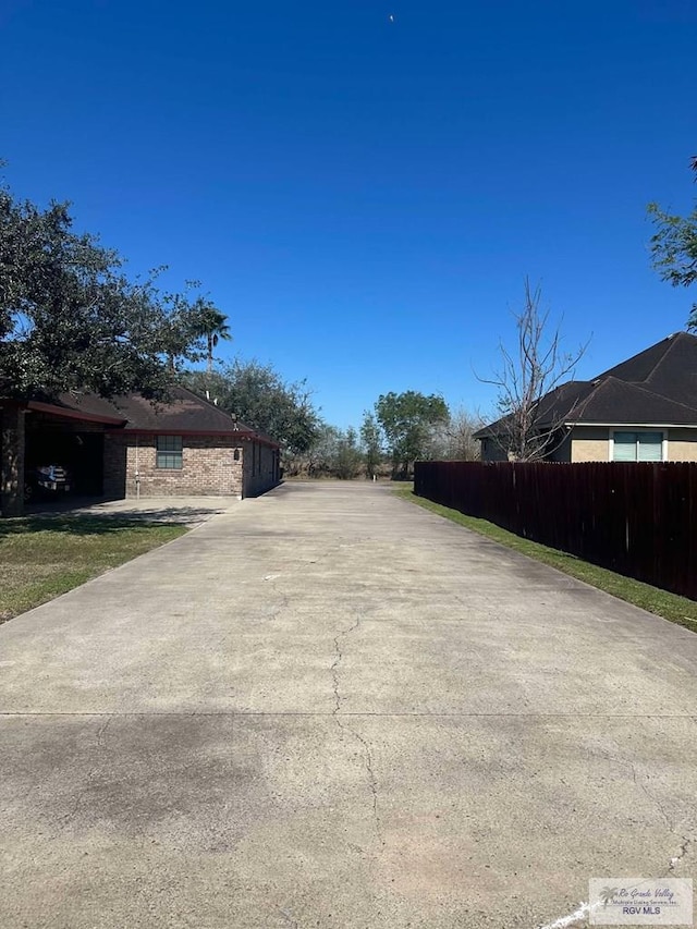 view of street with concrete driveway