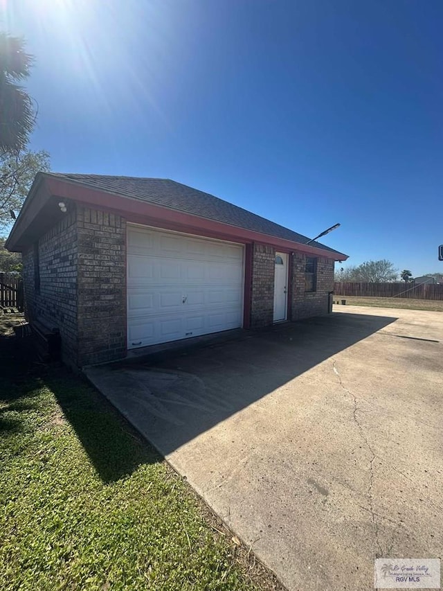 garage featuring concrete driveway