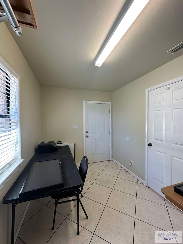 office area with visible vents, baseboards, and light tile patterned floors