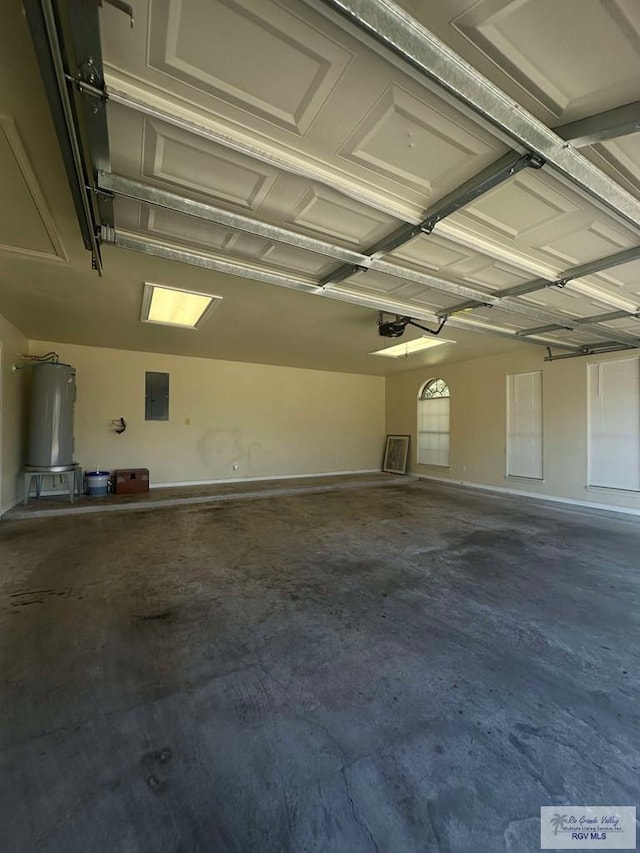 garage featuring electric panel, water heater, and a garage door opener