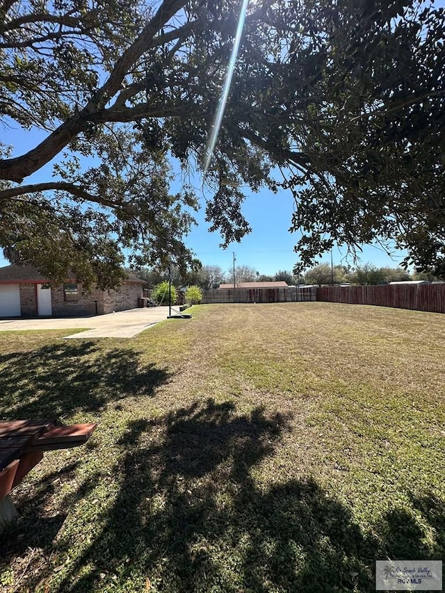 view of yard with fence and a patio