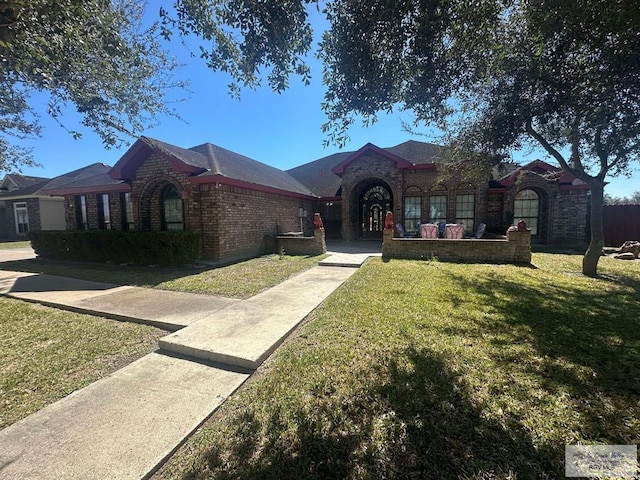 view of front of property with a front lawn and brick siding