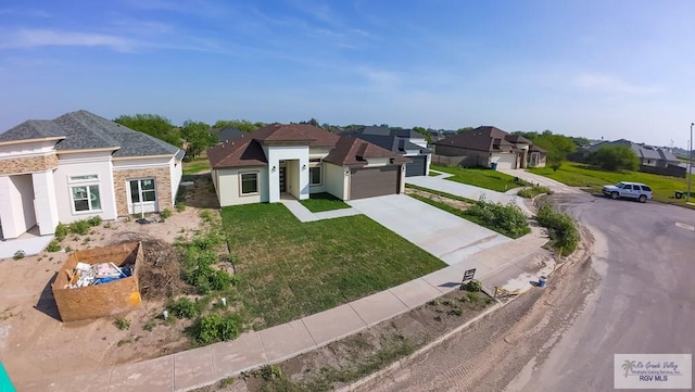 view of front of home featuring a residential view, concrete driveway, a garage, and a front lawn