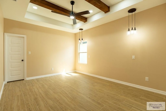 unfurnished room featuring baseboards, light wood-type flooring, beam ceiling, and a ceiling fan