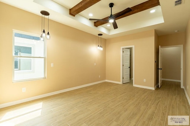 empty room featuring baseboards, visible vents, light wood-style flooring, and ceiling fan