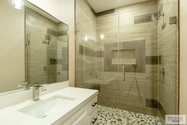 bathroom featuring vanity and a shower stall