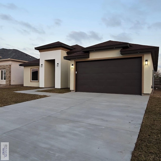 prairie-style house featuring a garage