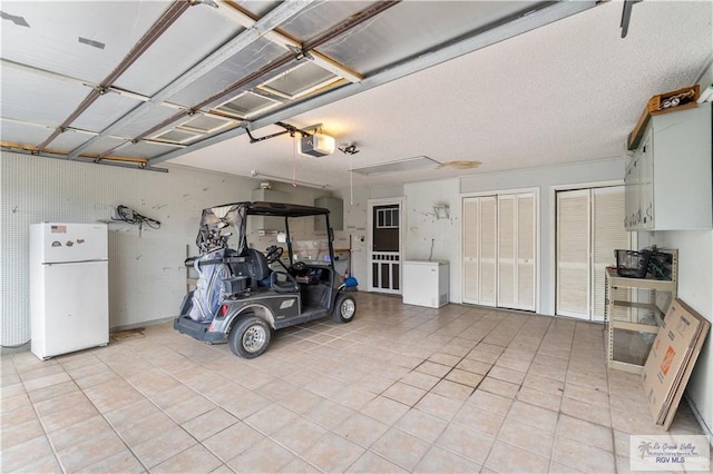 22 Shenandoah River Dr, Brownsville, TX 78520 - garage featuring freestanding refrigerator and a garage door opener
