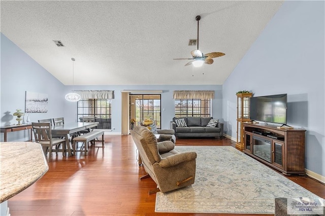 22 Shenandoah River Dr, Brownsville, TX 78520 - living room featuring a textured ceiling, a ceiling fan, wood finished floors, high vaulted ceiling, and baseboards