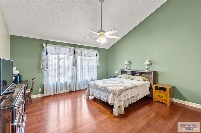 22 Shenandoah River Dr, Brownsville, TX 78520 - bedroom featuring a textured ceiling, wood finished floors, baseboards, vaulted ceiling, and ceiling fan