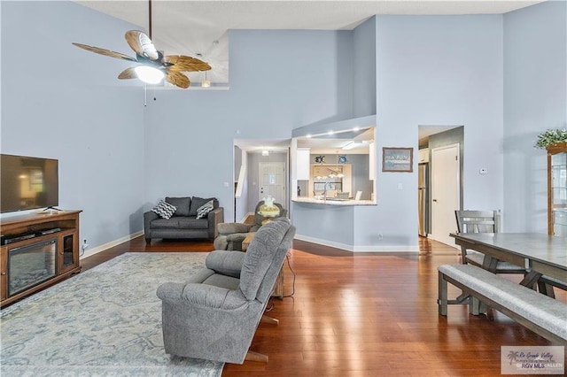 22 Shenandoah River Dr, Brownsville, TX 78520 - living area featuring a towering ceiling, a ceiling fan, wood finished floors, and baseboards