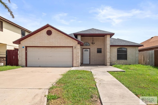 3673 Rey Enrique Dr, Brownsville, TX 78521 - view of front facade featuring an attached garage, brick siding, driveway, and roof with shingles
