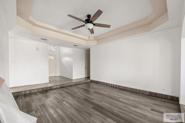 3673 Rey Enrique Dr, Brownsville, TX 78521 - spare room with a raised ceiling, ceiling fan, wood finished floors, and baseboards
