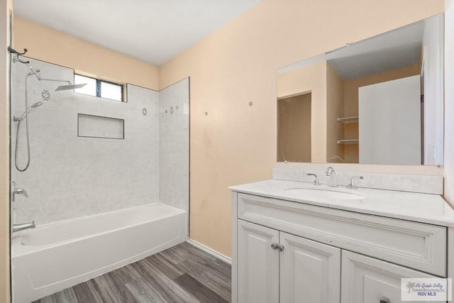 3673 Rey Enrique Dr, Brownsville, TX 78521 - bathroom with vanity, wood finished floors, washtub / shower combination, and baseboards