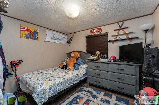 818 S 18th St, Alamo, TX 78516 - bedroom with a textured ceiling and wood finished floors