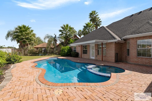 view of pool with an in ground hot tub and a patio