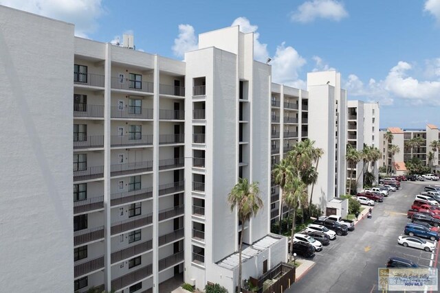 406 Padre Blvd Unit 207, South Padre Island, TX 78597 - view of apartment building / complex featuring uncovered parking