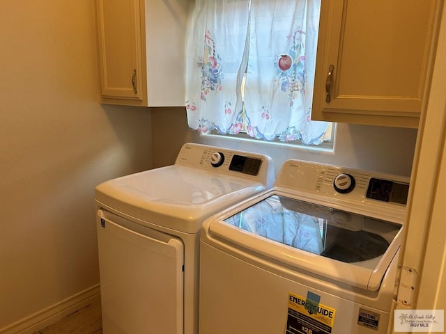 laundry area featuring washer and dryer and cabinets