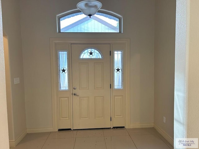 entryway with light tile patterned floors