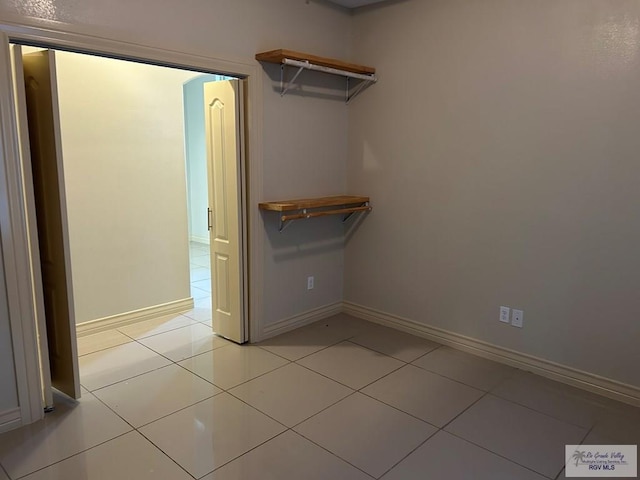 spacious closet featuring light tile patterned flooring