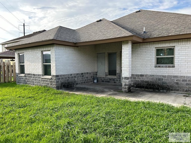 view of front of property with a patio area and a front lawn